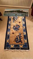 Both items laid out together, runner at bottom and tapestry at top