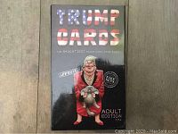 Photo of front of sealed Trump Cards Adult Edition box with caricature illustration and title text.