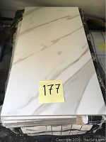 Top view of one tile with visible veining pattern and glossy polished surface.