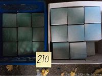 Boxed ceramic tiles organized by shade in crates, showing quantity and color variation.