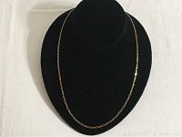 Chain draped on a black display bust showing overall design and length.