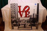 Front view of the 36x36 canvas art print showing the red LOVE sculpture and Philadelphia skyline backdrop.