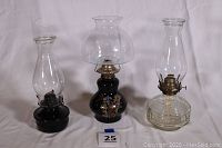 Photo of all 3 vintage oil lamps showing variety in design and shape.