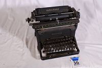Front angled view of the antique Underwood typewriter showing black metal body, keyboard, platen roller, and Underwood branding.