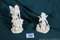 Pair of white garden fairy statues on a dark blue background, showing full view of both figures with size marker.