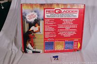 Back of the box showing the ResQ Ladder brand, product benefits, usage instructions, and length options.