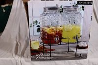 Box packaging showing two 1.5-gallon glass drink dispensers with metal stand, featuring textured dot glass and filled with colorful drinks.