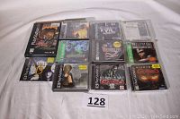 All 11 PlayStation game jewel cases arranged with lot number card