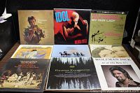 Front view of 9 vinyl album covers including Herman's Hermits, Billy Idol, Rex Harrison, classic orchestral albums, and Wolfman Jack singles compilation