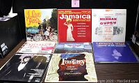 View of eight vinyl album covers from the lot including 'I Love Paris', 'Jamaica' by Lena Horne & Ricardo Montalban, 'The Merman and The Gypsy', and several others.