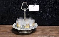 Silver plated EP on steel spinning castor set holding 5 frosted shot glasses with 22KT gold ship design and gold rims