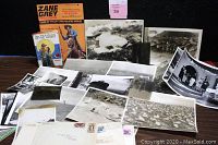 Lot overview showing brochure, book, photograph prints, negatives and envelopes