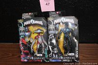 Two Power Rangers Legacy Collection figures displayed in original packaging, Black Ranger and Alpha 5, with visible Build A Megazord branding.