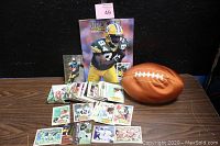 Photo showing Beckett football magazine, spread of trading cards, and bean bag football on a table against a black backdrop.
