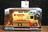 Wide-angle image of the Deadpool taco truck in original packaging alongside Deadpool action figure visible inside box.