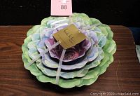 Stack of 4 Nicole Miller serving bowls viewed from above showing botanical designs and new tags.