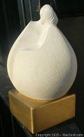 Front view of the abstract modernist lovers figurine showing the textured off-white stoneware and brass base.