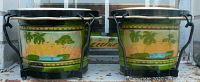 Front view of the pair of vintage Cuban twin bongo drums showing scenic landscape painted on both shells with palm trees and water