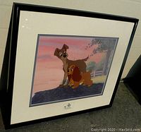 Front view of black-framed cel showing full artwork and mat