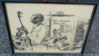Front view of framed art print showing four jazz musicians with instruments and New Orleans Dixieland Jazz sign in background.