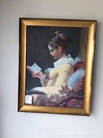 Full view of the framed oil painting depicting a young girl reading.