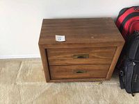 Top and front view of the night stand showing wood grain and drawer handles.