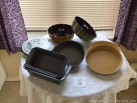 Photo showing assorted bakeware set with Bundt pans, loaf pans, round pans, springform pans on a table.