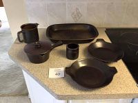Top view of all ceramic pieces showing glossy black finish and shapes
