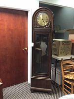 Full view of oak German grandfather clock case in room setting