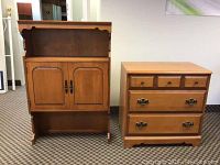 Full view of buffet on right with drawers and hutch on left with doors and open shelf, wood finish and metal handles.