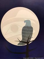 Artwork showing an eagle on a branch with a large moon and indigenous art motif.