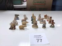 Photo showing 20 miniature figurines arranged on table, including animals and characters like the gingerbread man and Puss in Boots.