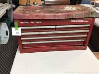 Closed red Sears Craftsman toolbox showing worn and rusted exterior with multiple drawers