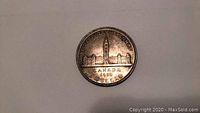 Close-up photo of the 1939 Canada silver dollar coin showing the Parliament Buildings side with inscriptions.