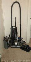 Kirby 80th Anniversary vacuum and all included accessories arranged on floor against wall.