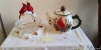 Front view of the Cardinal-themed ceramic teapot paired with the candy dish on a table.