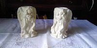 Pair of cream-colored angel candle holders