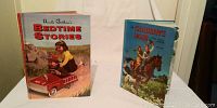 Two vintage children's books: "Uncle Arthur Bedtime Stories" with a cover illustration of children in a red toy car; "Children's Hour" with cover illustration of children riding a horse.