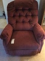Front view of the La-Z-Boy recliner showing overall shape, tufted back, and footrest in closed position