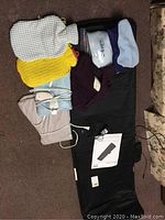 Full view of massage mat, heating pads, hot water bottle, and accessories arranged on the floor