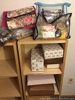 Shelf top with three organizer bags and boxed skincare products