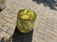 Green handmade lampshade with visible aging and wear, top view showing the diameter and inside fittings.