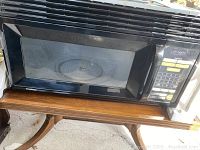 Front view of the GoldStar black built-in microwave oven showing the door and control panel.