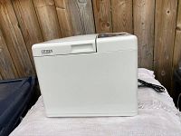 Front and side view of the white Citizen electric bread maker with power cord visible behind.