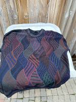 Folded view of a multicolored knit sweater showing pattern and texture.