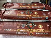 Photo showing three bundled Java-Log firelogs wrapped in maroon packaging for indoor/outdoor use