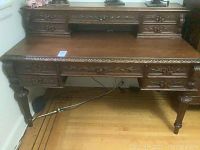 Front overall view of carved oak desk with attached writing hutch