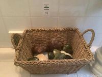 Woven basket filled with various heart-shaped stones in mixed colors and sizes.