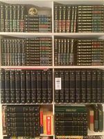 Full view of bookshelf with top four shelves holding Encyclopaedia Britannica Great Books volumes and ceramic owl bookend