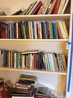 Three-shelf unit holding over 100 assorted books